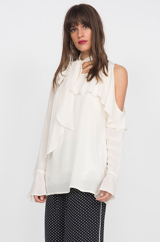 Model is wearing the Silk Ruffle Cold-Shoulder Top in egg white with the Polka Dot Silk Pajama Pants.