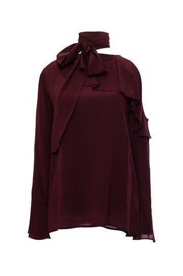 The Silk Ruffle Cold-Shoulder Top in burgundy.