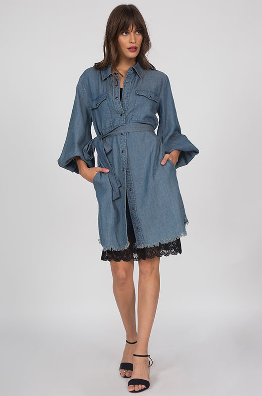 Model is wearing the JC Denim Dress in navy, buttoned only in the middle front torso and tied at the waist with the included denim sash, and worn with the Marilyn Lace Silk Slip Dress in black underneath. Also worn with open toe, low heel sandals.